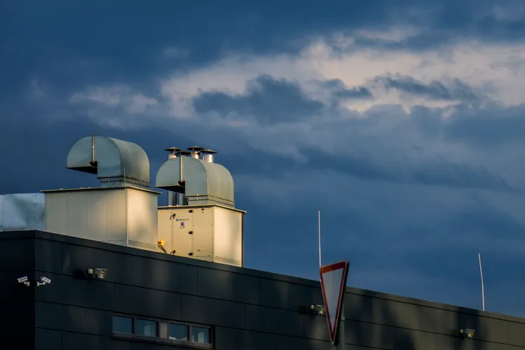 Industrial rooftop exhaust ventilation pipes on commercial building in Irvington NJ
